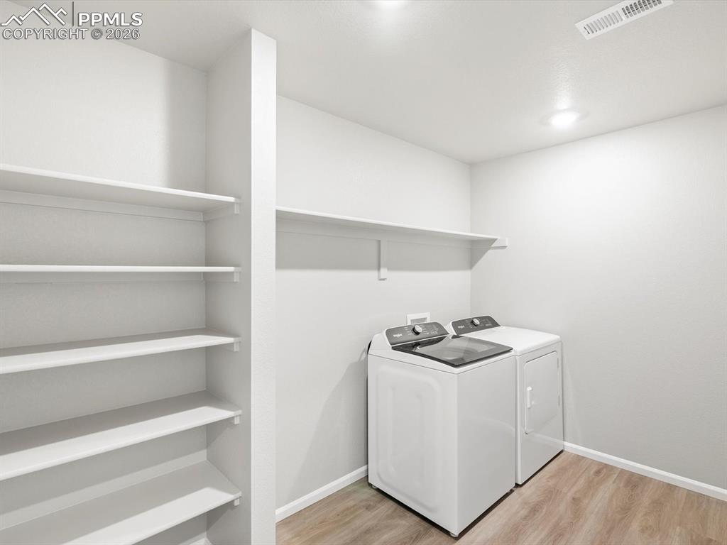6754 Roundtail Way Colorado Springs, CO 80925 - Photo 22 of 31 a room with storage and utility