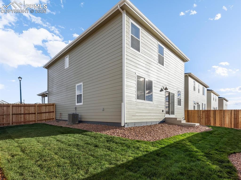 6754 Roundtail Way Colorado Springs, CO 80925 - Photo 29 of 31 a front view of a house with a yard