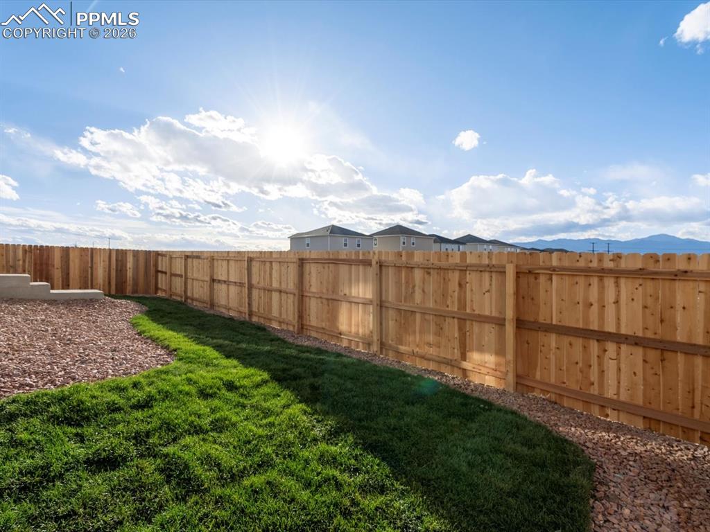 6754 Roundtail Way Colorado Springs, CO 80925 - Photo 30 of 31 a view of a backyard with sitting area