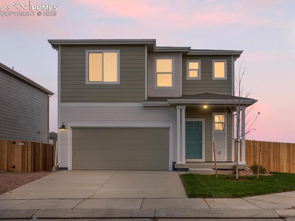 6754 Roundtail Way Colorado Springs, CO 80925 - Photo 31 of 31 a front view of a house with a yard and garage
