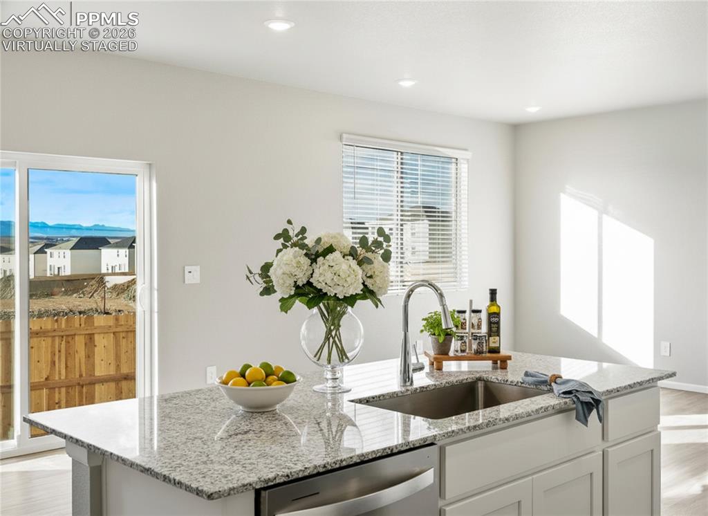 6754 Roundtail Way Colorado Springs, CO 80925 - Photo 6 of 31 a kitchen with sink and window