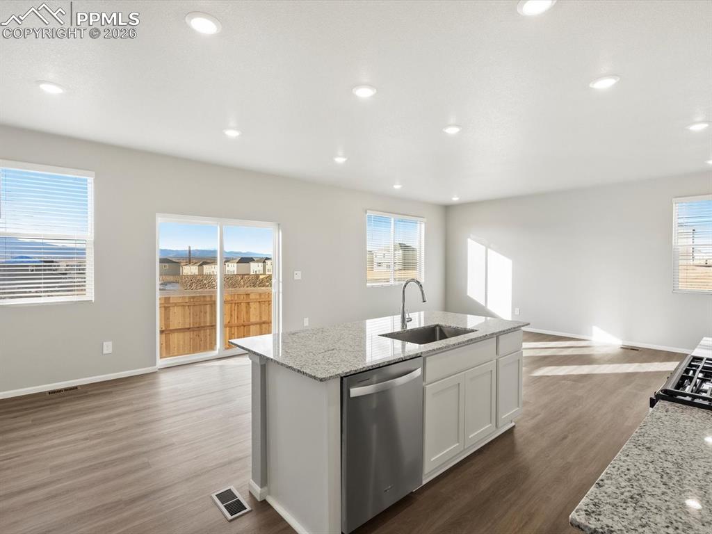 6754 Roundtail Way Colorado Springs, CO 80925 - Photo 10 of 31 a kitchen with granite countertop sink and window