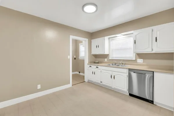 a kitchen with granite countertop a sink and a stove