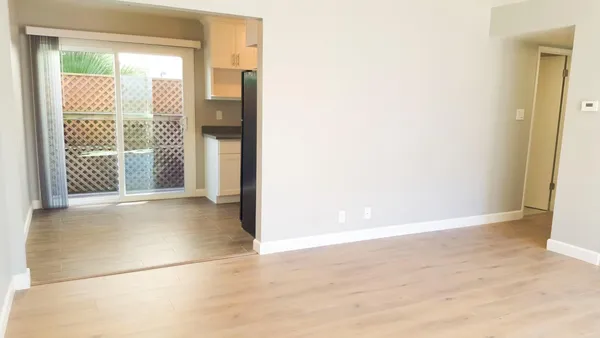 a view of a big room with closet and wooden floor