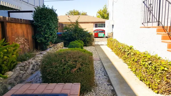 a view of house with a yard