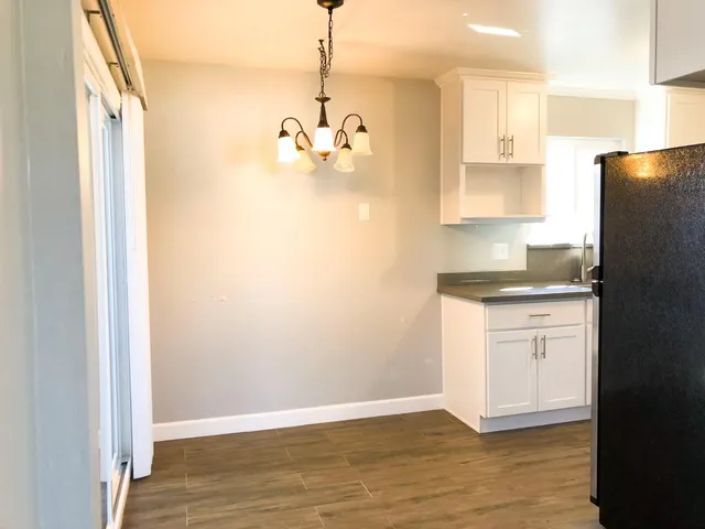 a view of a room with wooden floor