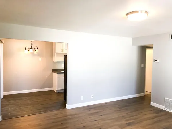 a kitchen with stainless steel appliances granite countertop a sink a stove and a refrigerator