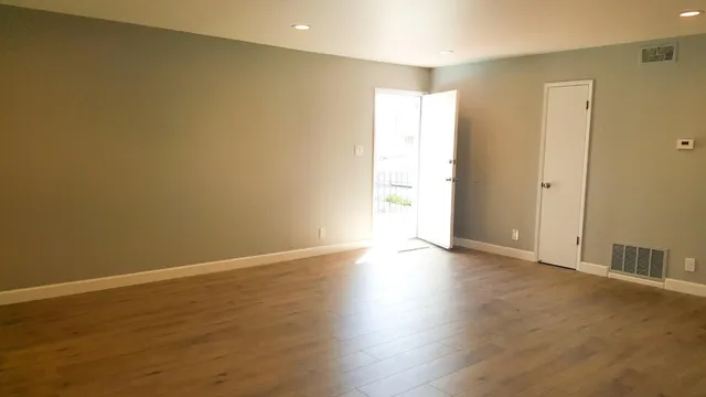 wooden floor in an empty room with a window