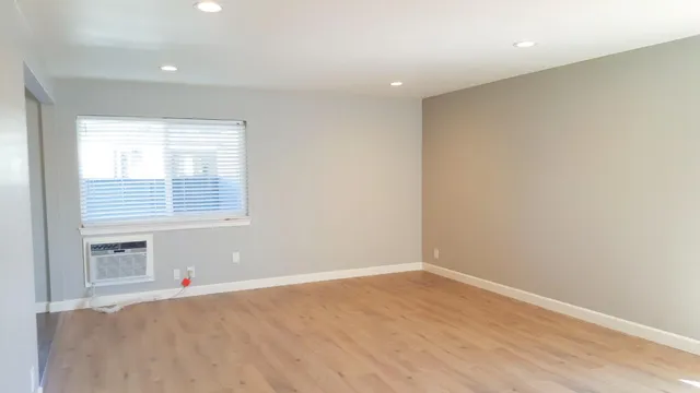 a view of a kitchen with wooden floor and a sink