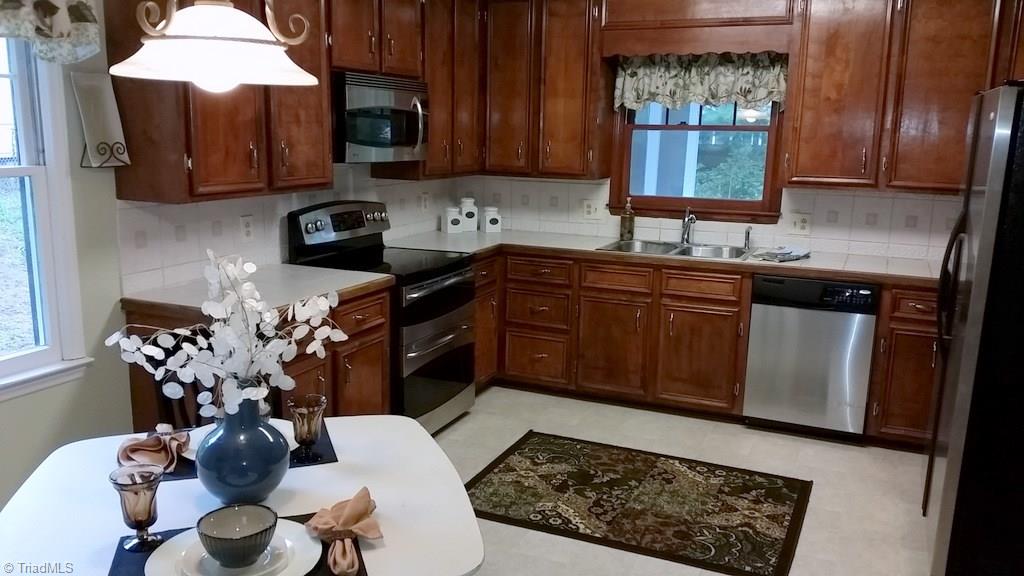 3510 Court Road Winston-Salem, NC 27106 - Photo 10 of 27 Bright and attractive Kitchen with new flooring, refreshed solid wood cabinetry and stainless appliances