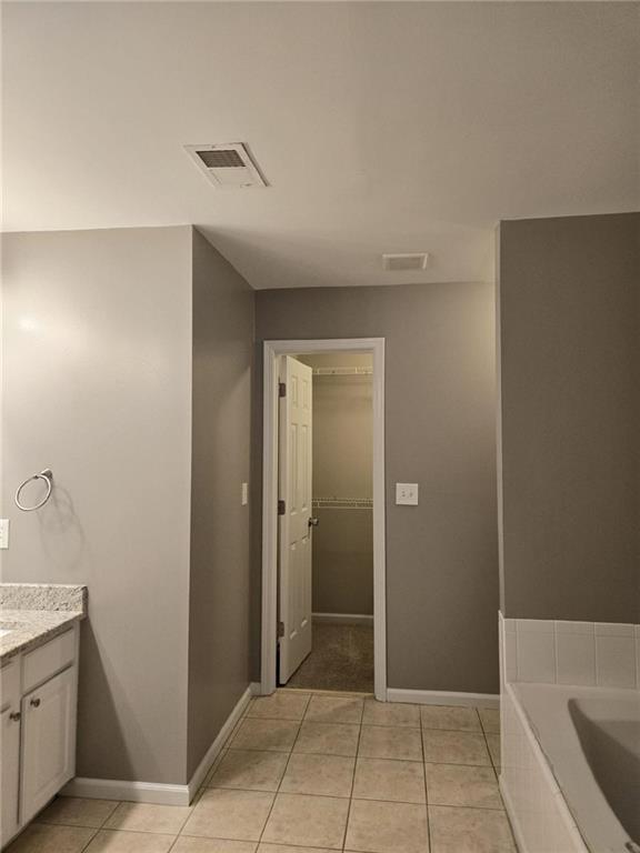 5315 Sherwin Drive Lilburn, GA 30047 - Photo 11 of 16 a spacious bathroom with a granite countertop sink a toilet and mirror