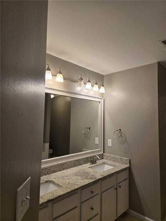 5315 Sherwin Drive Lilburn, GA 30047 - Photo 12 of 16 a bathroom with a sink and a mirror