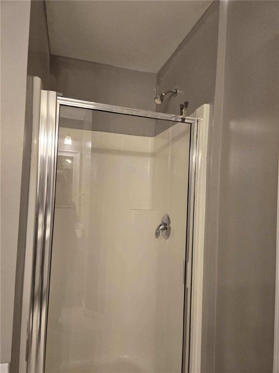 5315 Sherwin Drive Lilburn, GA 30047 - Photo 13 of 16 a bathroom with a glass shower door
