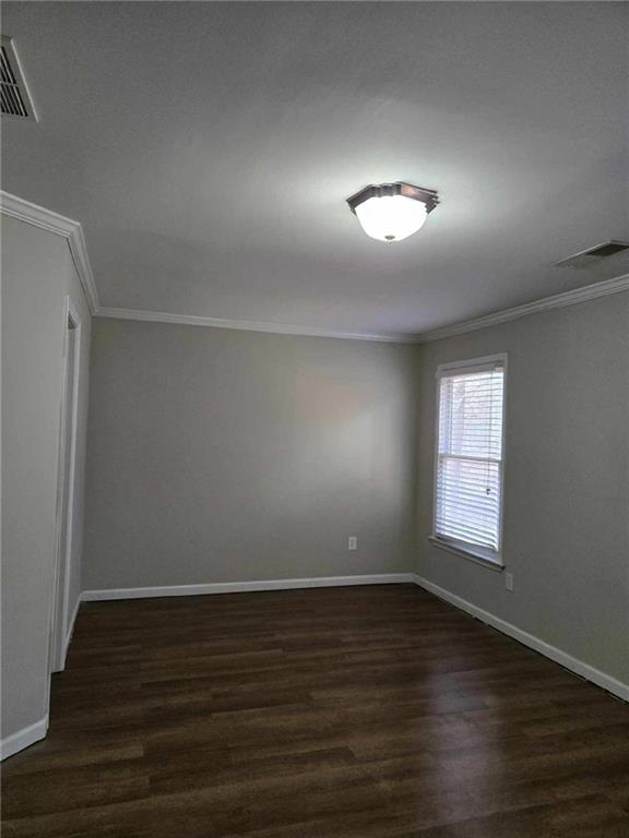 5315 Sherwin Drive Lilburn, GA 30047 - Photo 15 of 16 an empty room with wooden floor and windows