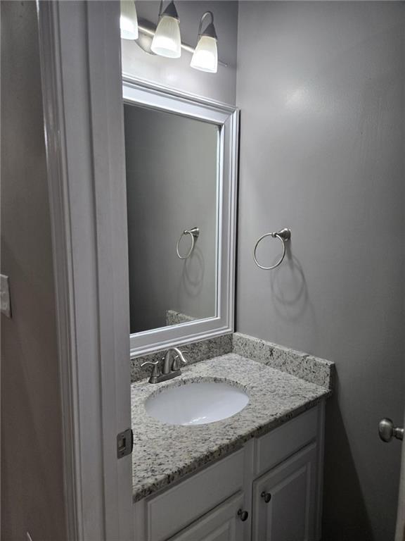 5315 Sherwin Drive Lilburn, GA 30047 - Photo 5 of 16 a bathroom with a granite countertop sink and a mirror