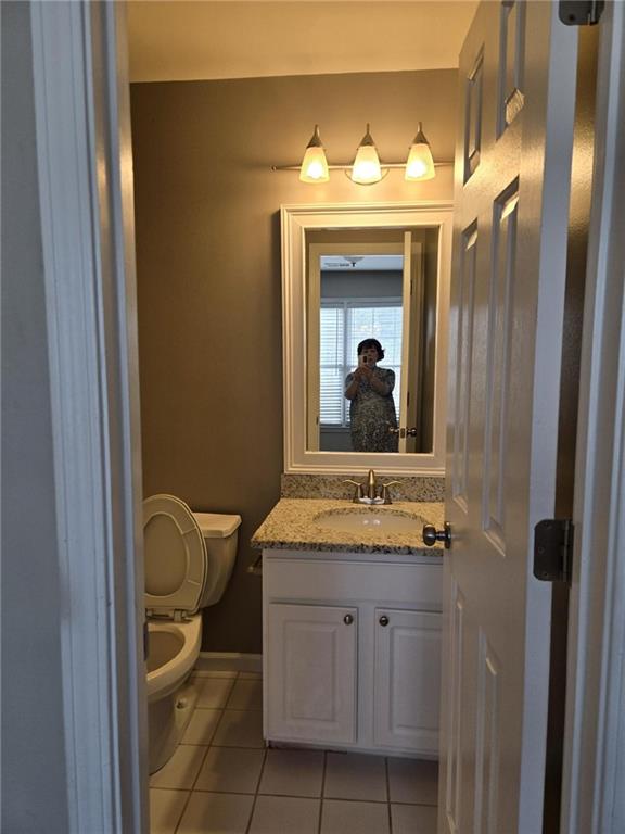 5315 Sherwin Drive Lilburn, GA 30047 - Photo 8 of 16 a bathroom with a granite countertop sink vanity mirror and toilet