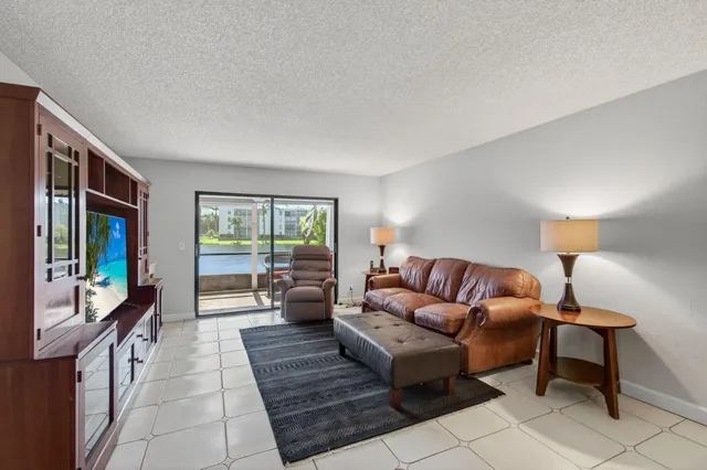 a kitchen with stainless steel appliances granite countertop a refrigerator a stove a sink and a microwave