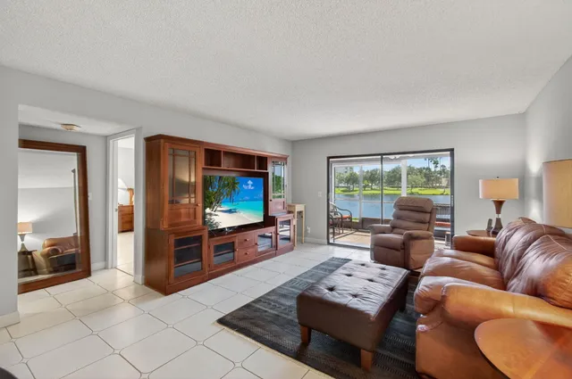 a spacious bedroom with a bed and a chandelier