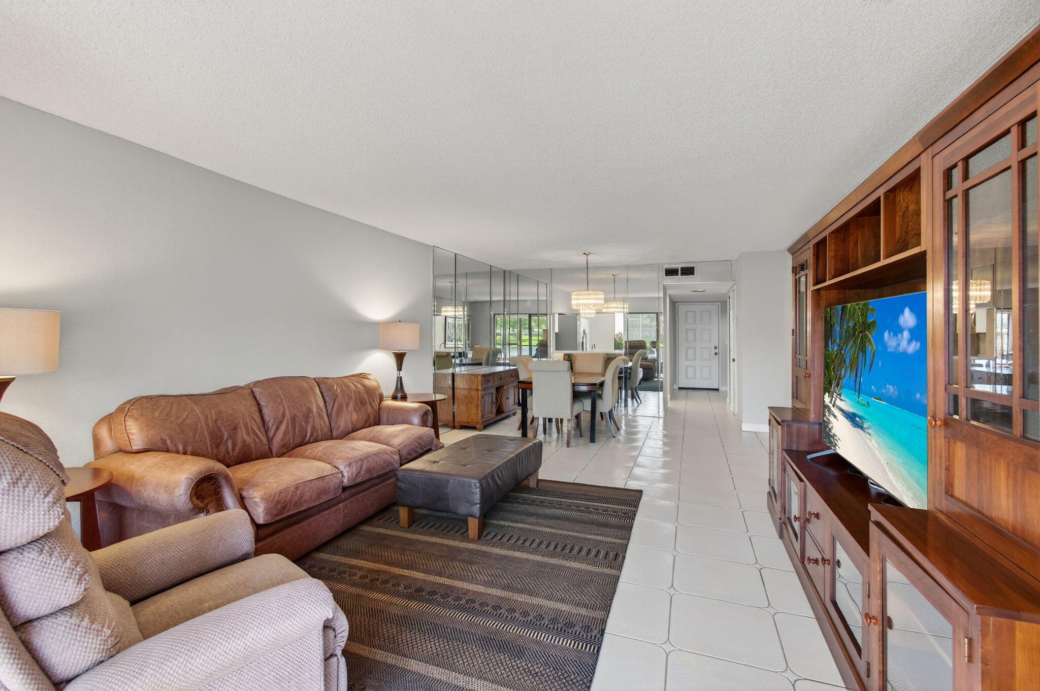 7340 Amberly Lane, Unit 101 Delray Beach, FL 33446 - Photo 17 of 90 a living room with furniture two large window and a rug