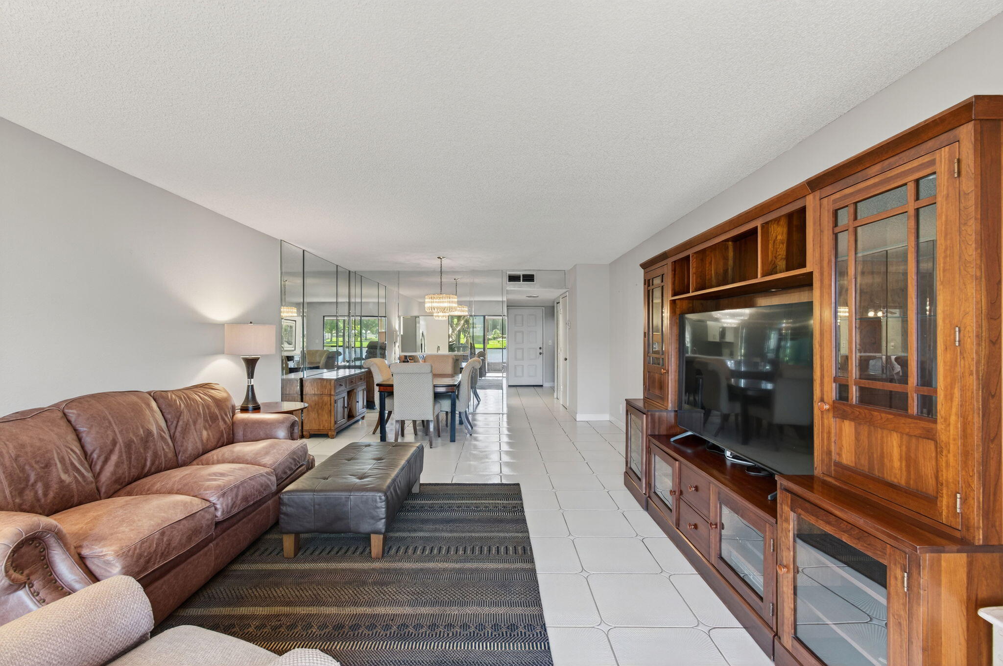 7340 Amberly Lane, Unit 101 Delray Beach, FL 33446 - Photo 18 of 90 a living room with furniture and a flat screen tv