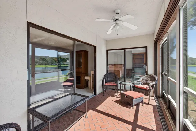 a spacious bedroom with a bed a chandelier and dresser