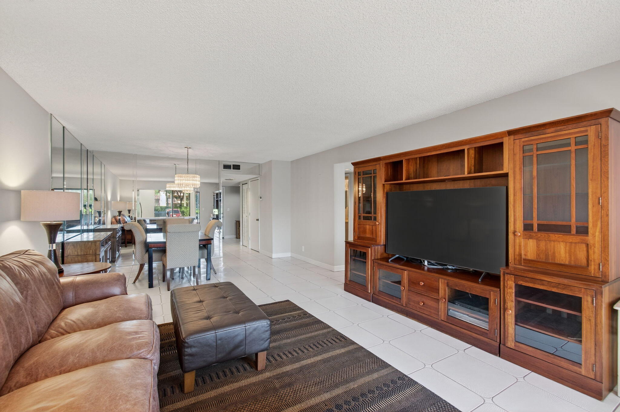 7340 Amberly Lane, Unit 101 Delray Beach, FL 33446 - Photo 22 of 90 a living room with furniture and a flat screen tv