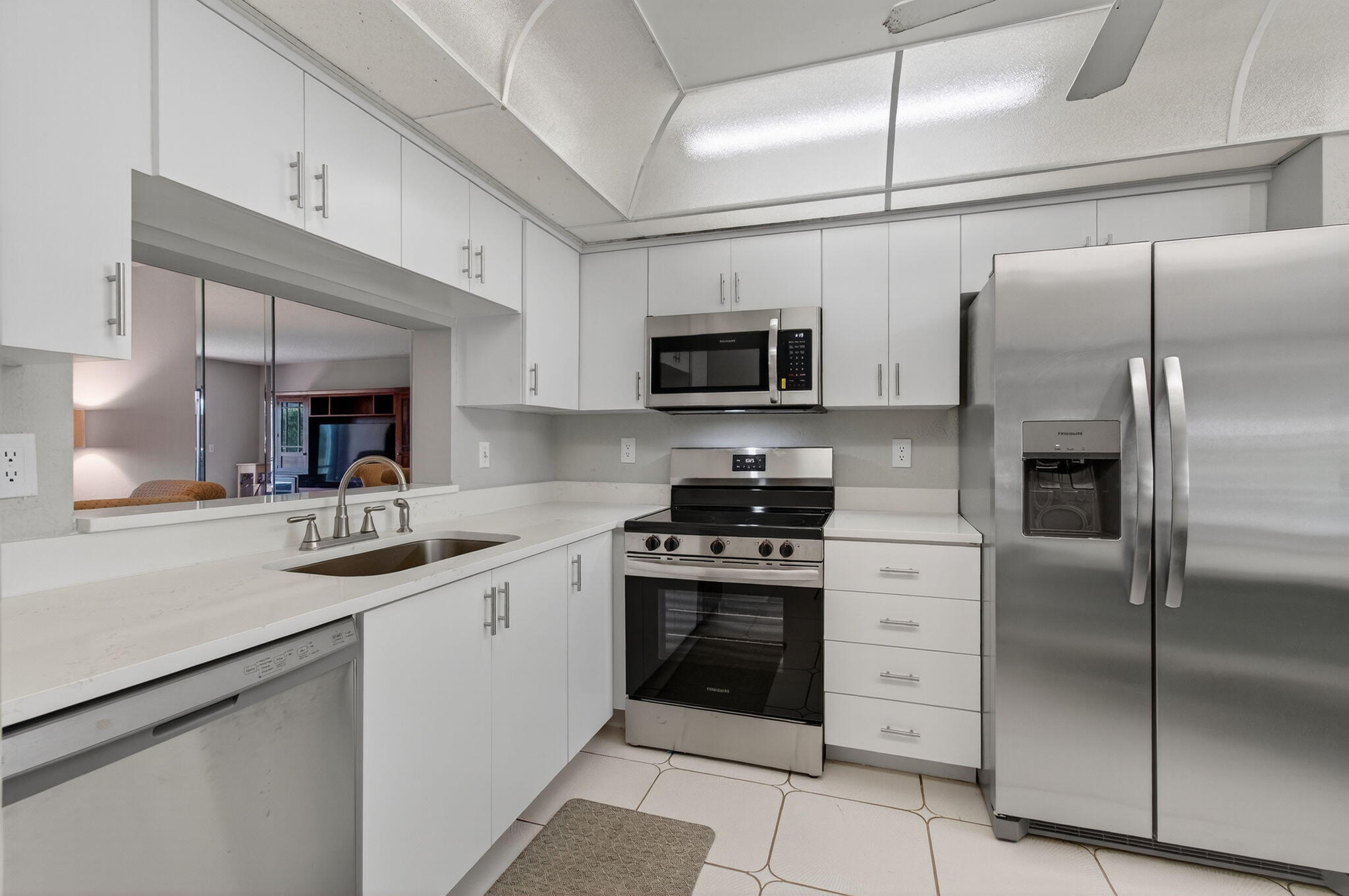 7340 Amberly Lane, Unit 101 Delray Beach, FL 33446 - Photo 25 of 90 a kitchen with a sink stainless steel appliances and cabinets