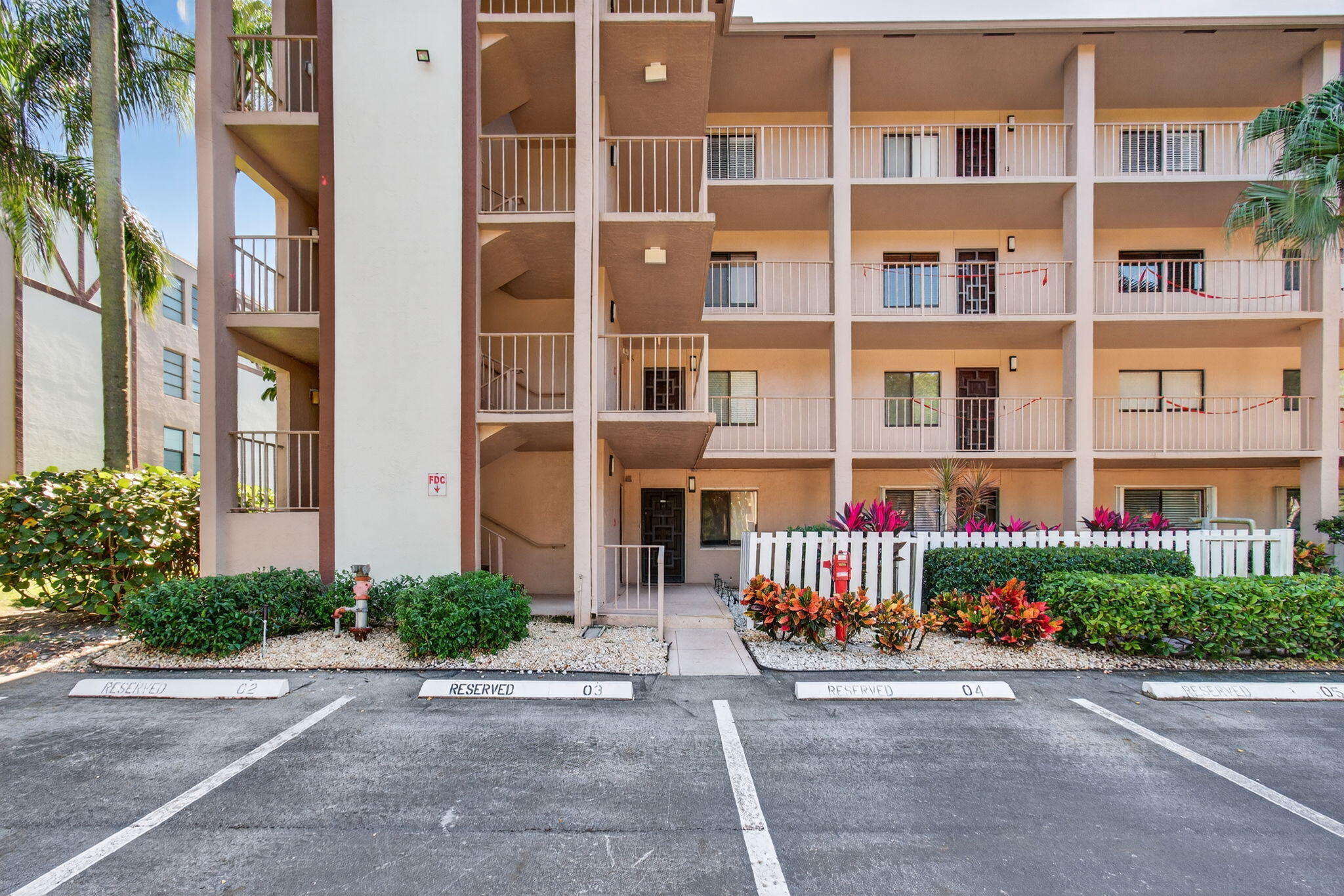 7340 Amberly Lane, Unit 101 Delray Beach, FL 33446 - Photo 3 of 90 a building with potted plants in front of it