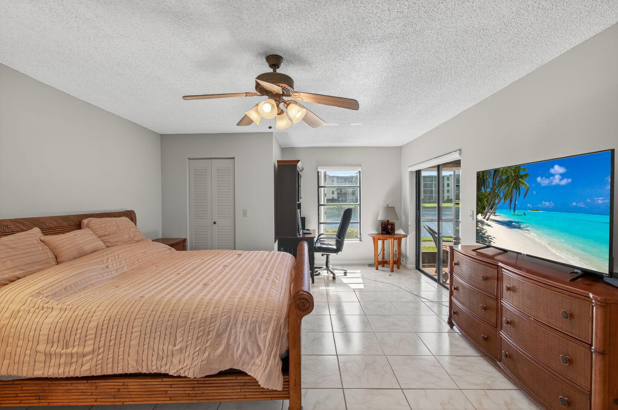 7340 Amberly Lane, Unit 101 Delray Beach, FL 33446 - Photo 32 of 90 a bedroom with a bed and large mirror