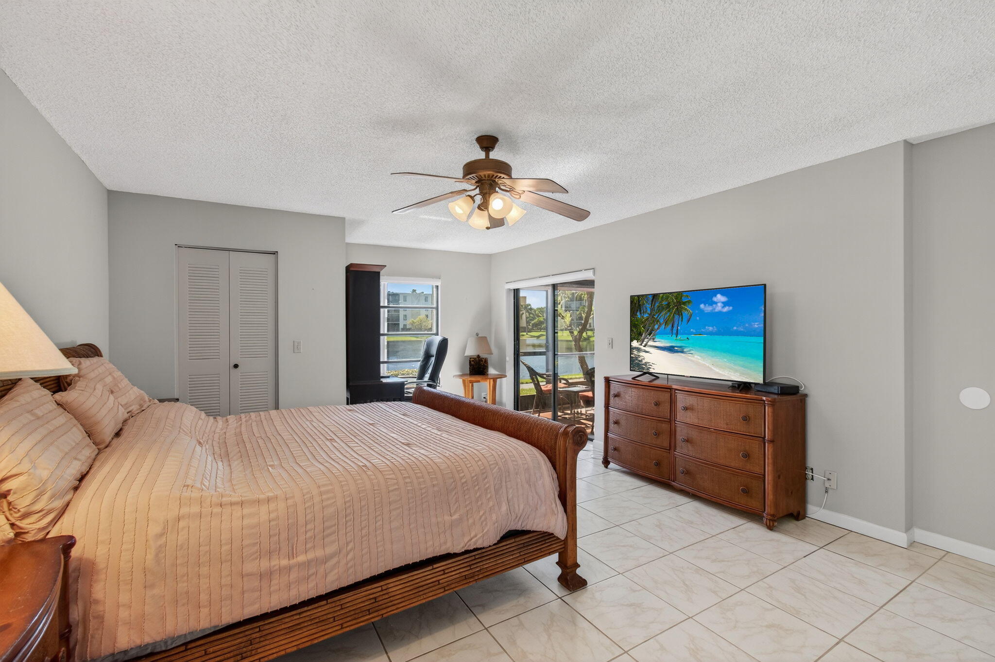 7340 Amberly Lane, Unit 101 Delray Beach, FL 33446 - Photo 33 of 90 a bedroom with a bed and a dresser