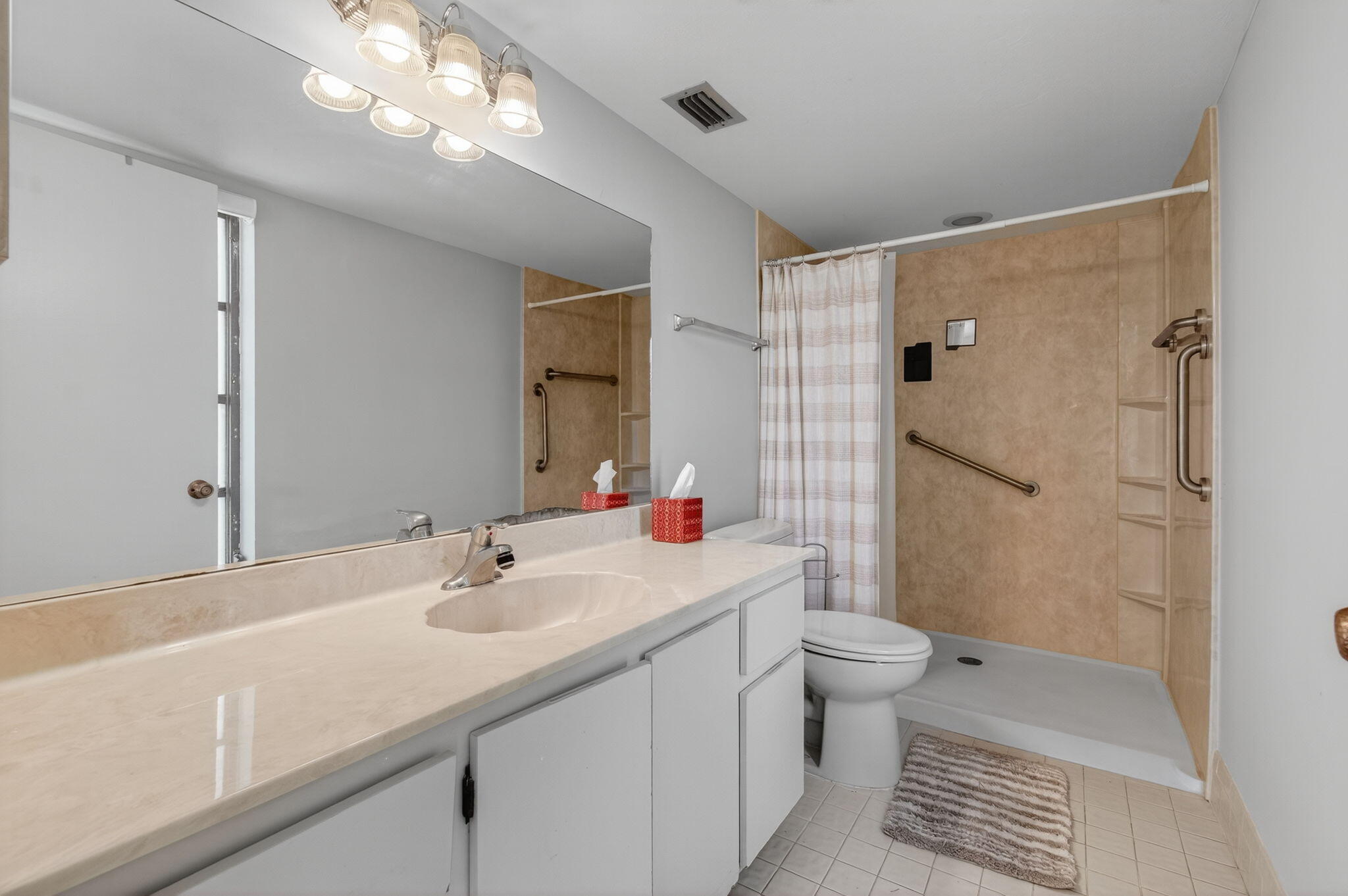 7340 Amberly Lane, Unit 101 Delray Beach, FL 33446 - Photo 41 of 90 a bathroom with a sink a toilet a shower and a mirror