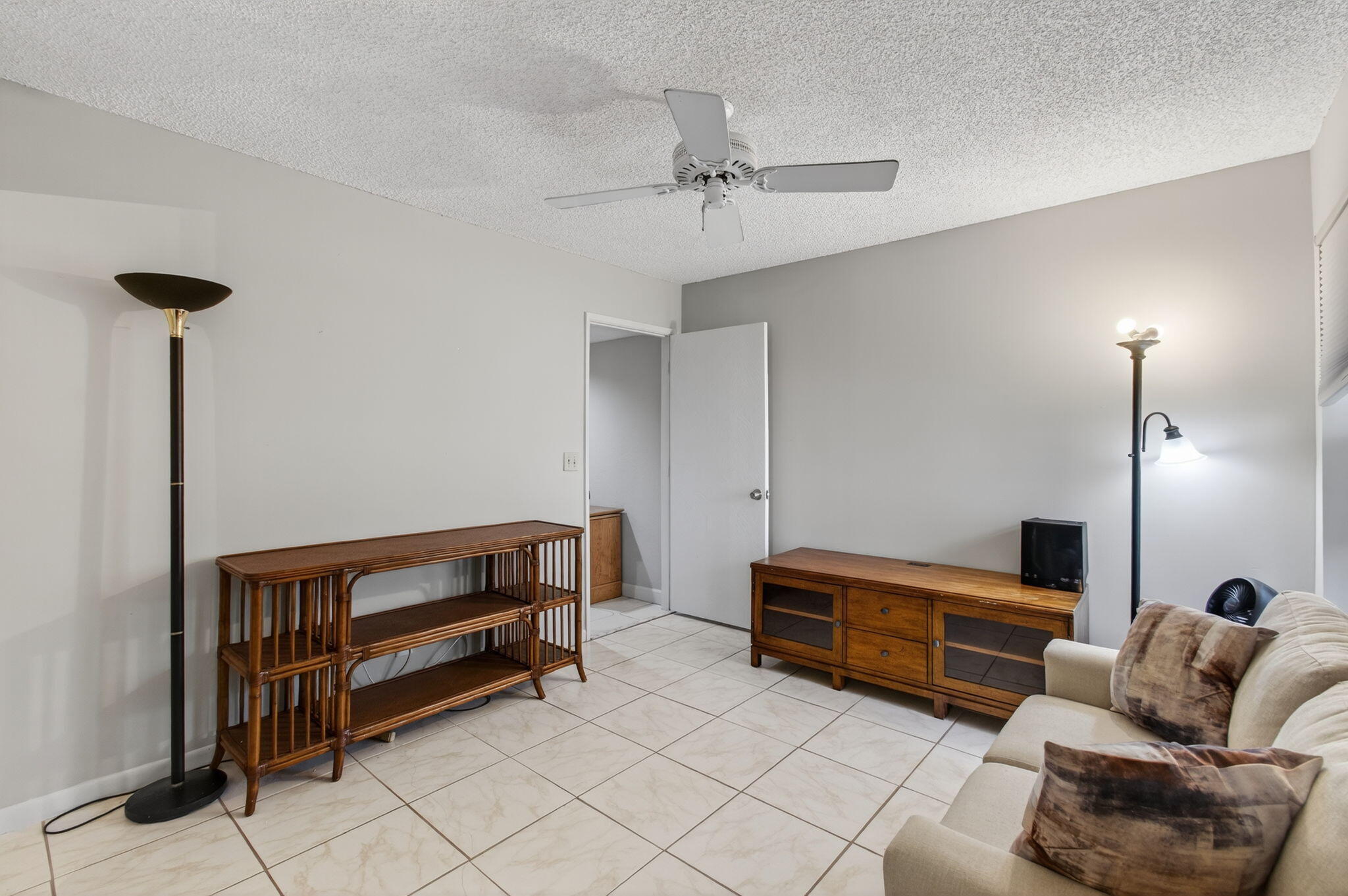 7340 Amberly Lane, Unit 101 Delray Beach, FL 33446 - Photo 46 of 90 a bedroom with furniture and a chandelier