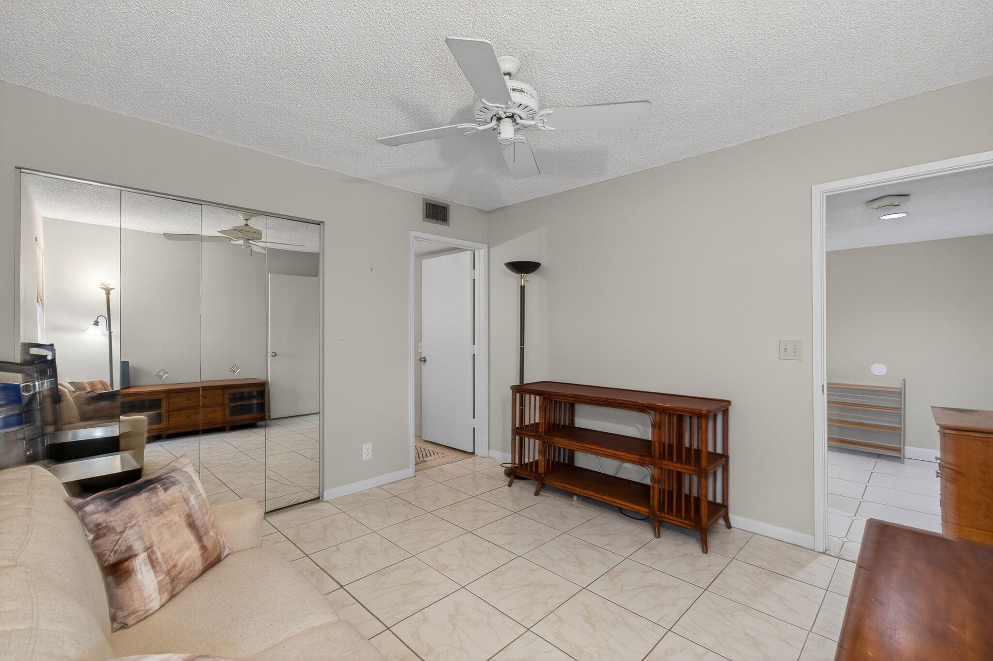 7340 Amberly Lane, Unit 101 Delray Beach, FL 33446 - Photo 47 of 90 a bedroom with furniture and a ceiling fan