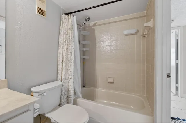 an aerial view of residential houses with outdoor space and street view