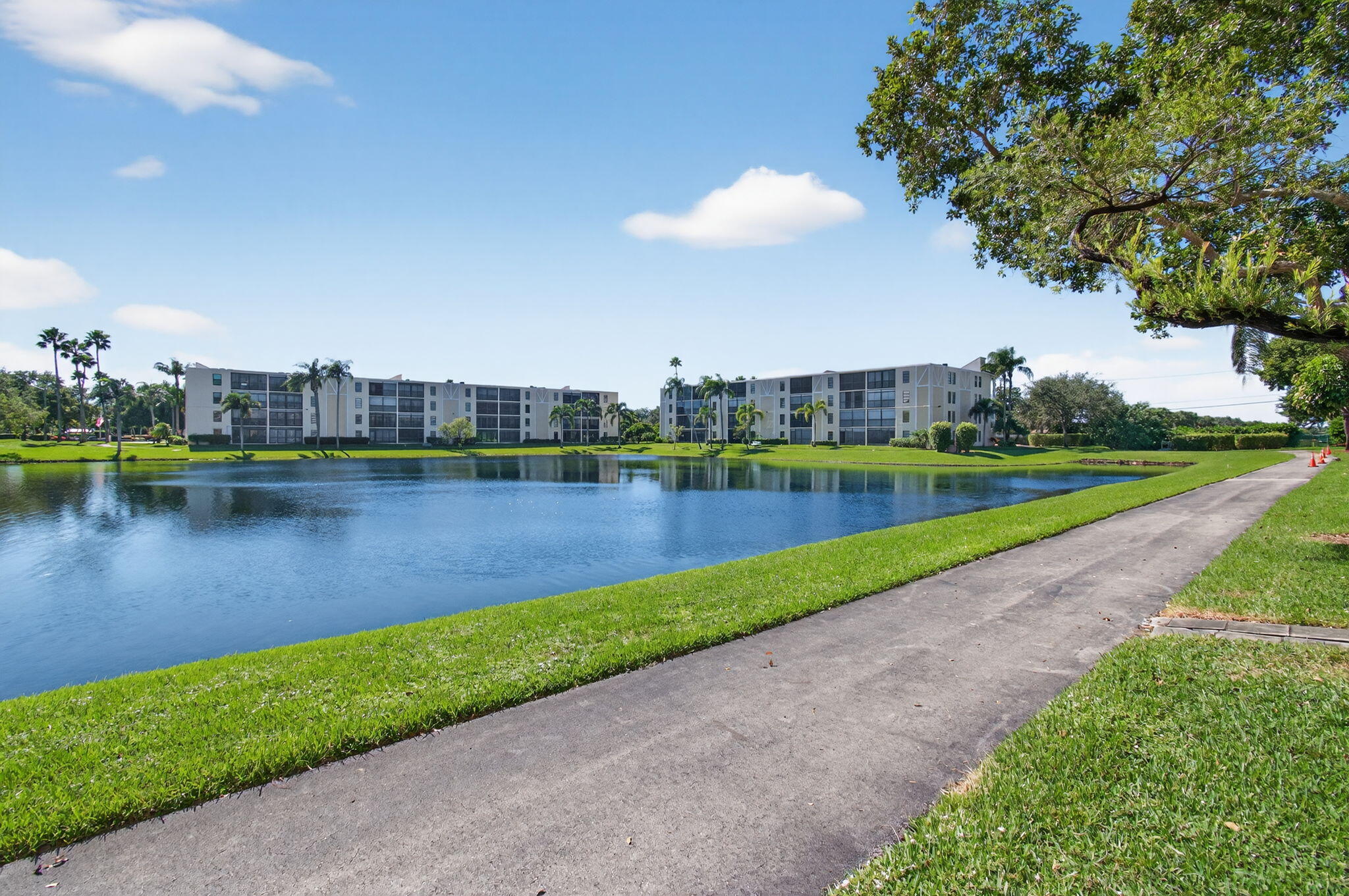 7340 Amberly Lane, Unit 101 Delray Beach, FL 33446 - Photo 59 of 90 a view of a lake with houses in the background