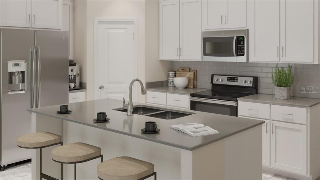 4754 Maple Cross Drive Kissimmee, FL 34746 - Photo 2 of 19 a kitchen with stainless steel appliances granite countertop a sink and a white cabinets