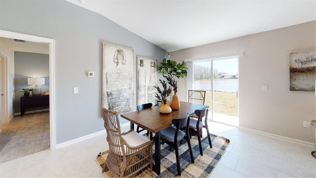 4754 Maple Cross Drive Kissimmee, FL 34746 - Photo 3 of 19 a view of a dining room with furniture and a potted plant