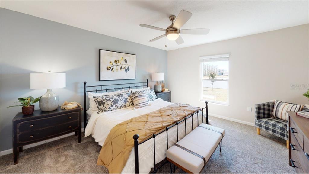 4754 Maple Cross Drive Kissimmee, FL 34746 - Photo 8 of 19 a bedroom with a bed and window