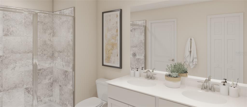 4754 Maple Cross Drive Kissimmee, FL 34746 - Photo 10 of 19 a bathroom with double sink and a mirror