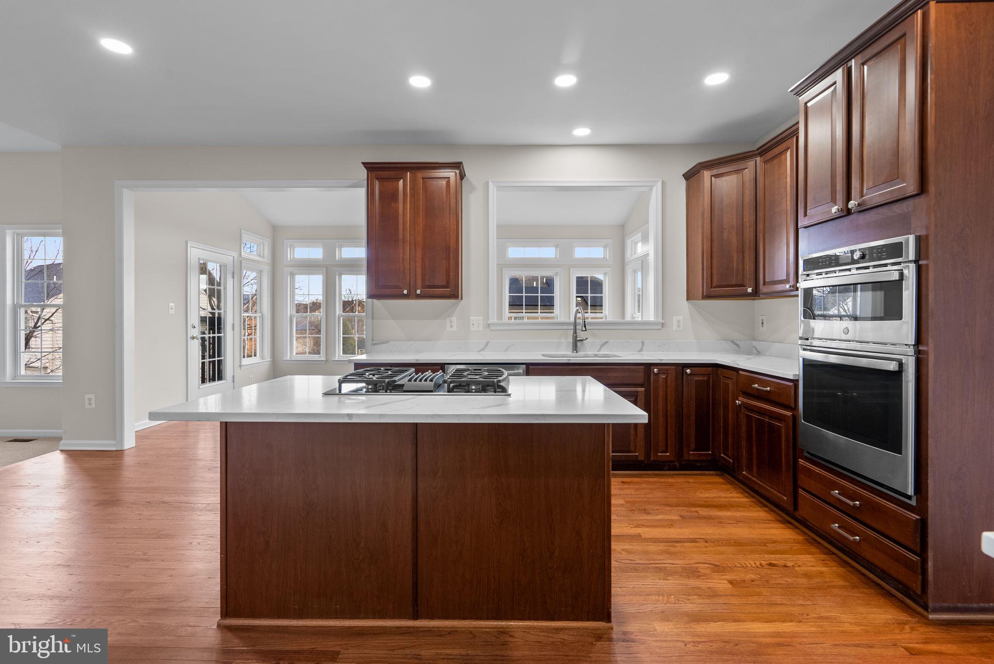 7604 Finglas Court Laurel, MD 20707 - Photo 11 of 48 a kitchen with stainless steel appliances granite countertop a stove a sink and a microwave