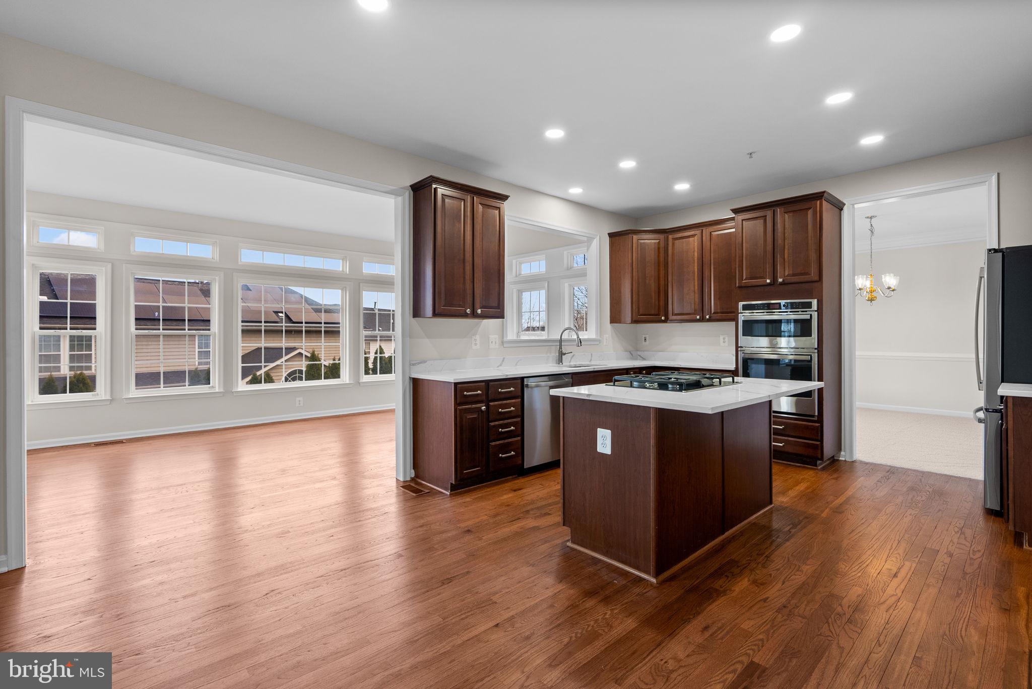 7604 Finglas Court Laurel, MD 20707 - Photo 12 of 48 a large kitchen with stainless steel appliances and wooden cabinets