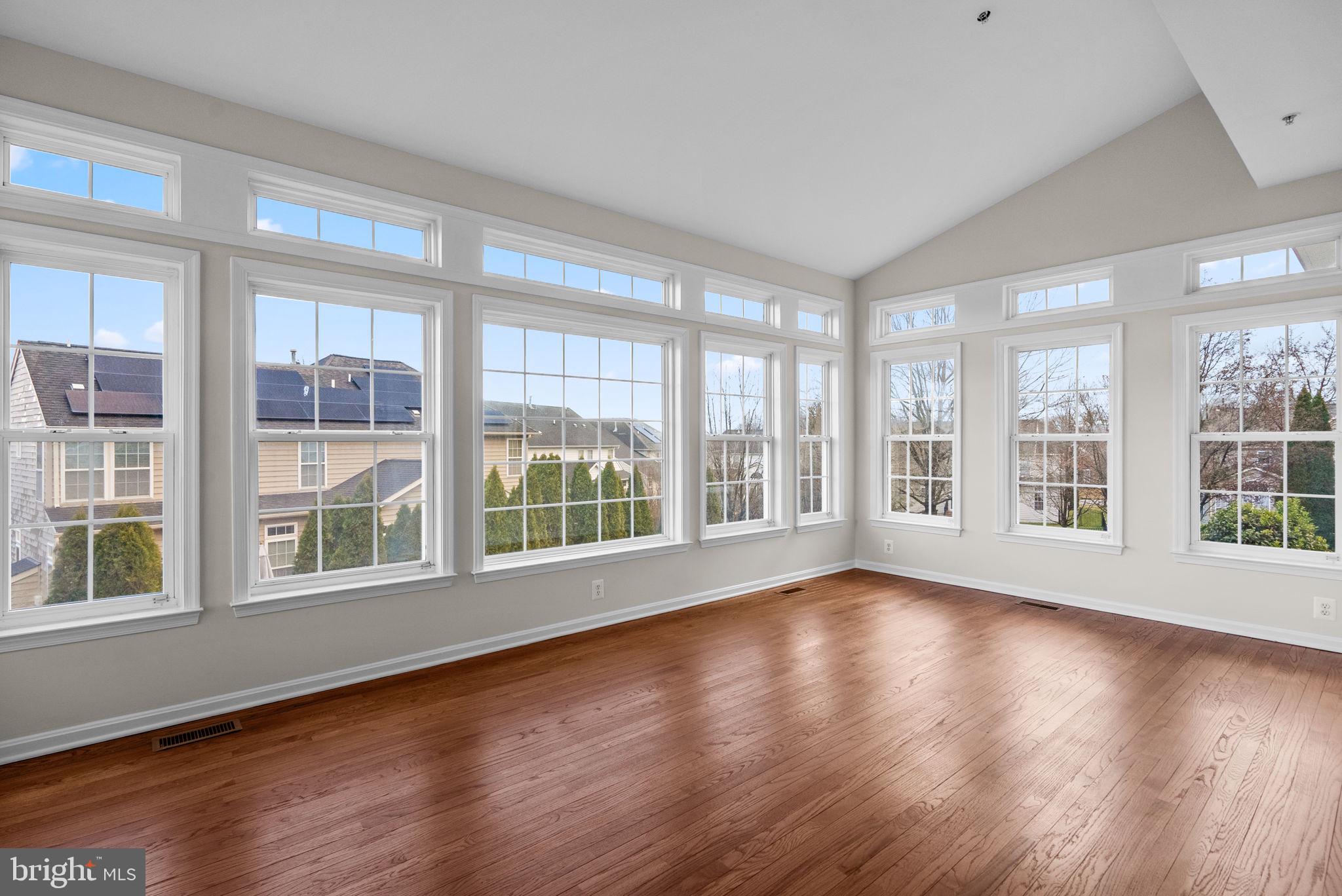 7604 Finglas Court Laurel, MD 20707 - Photo 14 of 48 a view of empty room with wooden floor and floor to ceiling window