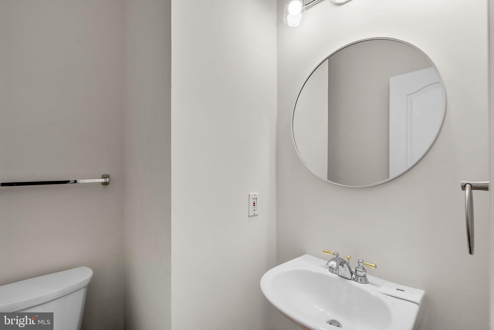 7604 Finglas Court Laurel, MD 20707 - Photo 20 of 48 a bathroom with a sink a mirror and a toilet