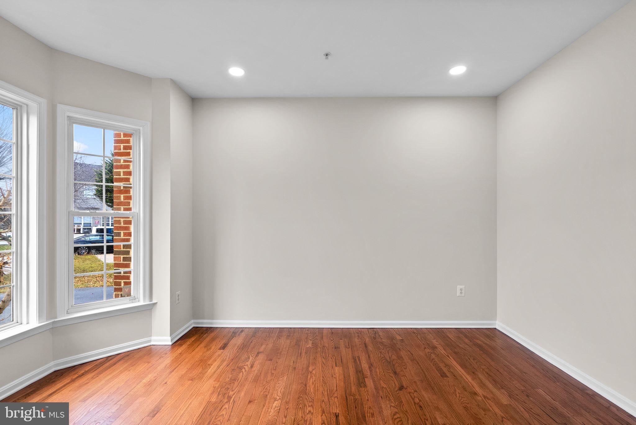 7604 Finglas Court Laurel, MD 20707 - Photo 22 of 48 an empty room with wooden floor and windows