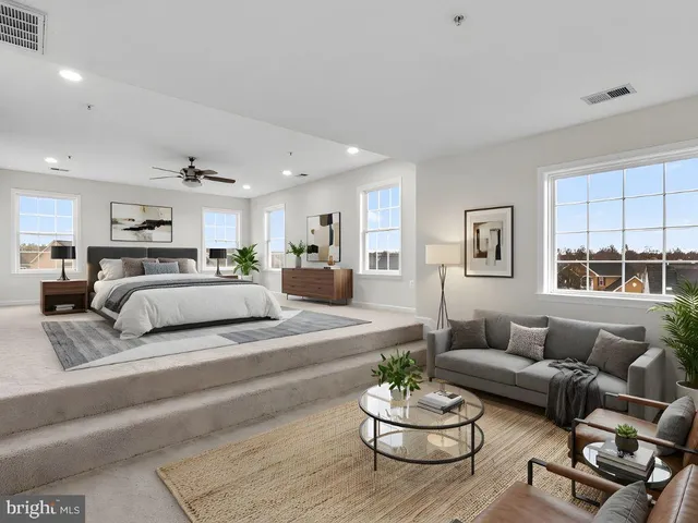 a living room with furniture kitchen view and a window