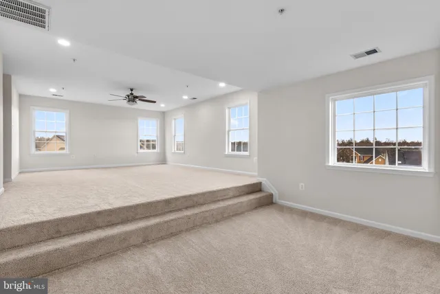 a spacious bedroom with a large bed and a window