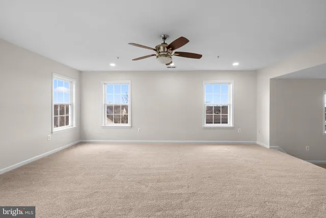 a view of a livingroom with a ceiling fan and window