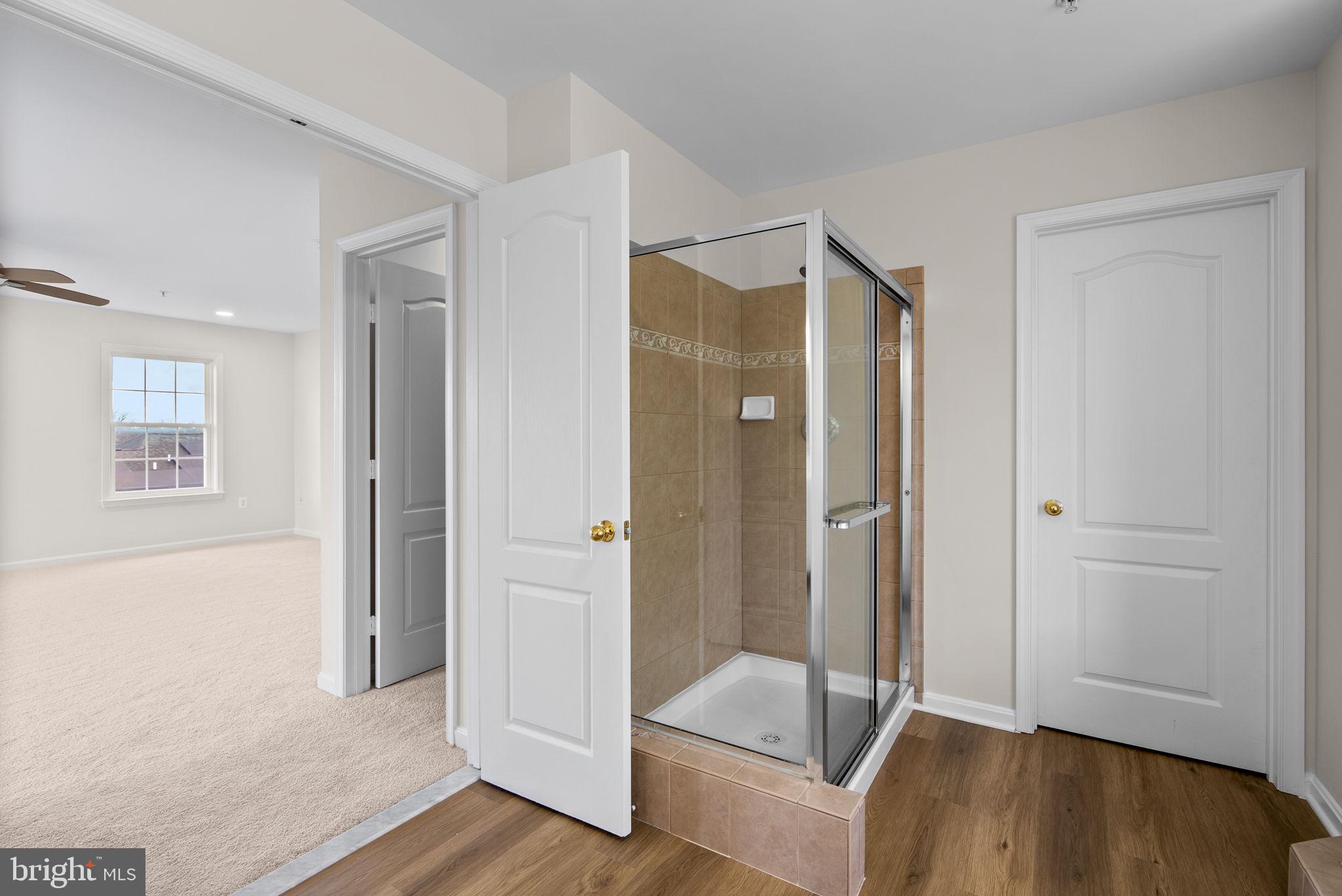 7604 Finglas Court Laurel, MD 20707 - Photo 34 of 48 a bathroom with a tub and shower