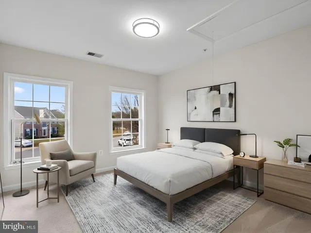 a bedroom with a bed wooden floor and window