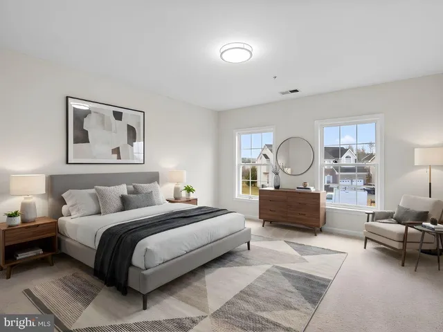 a bedroom with a bed a couch and dresser